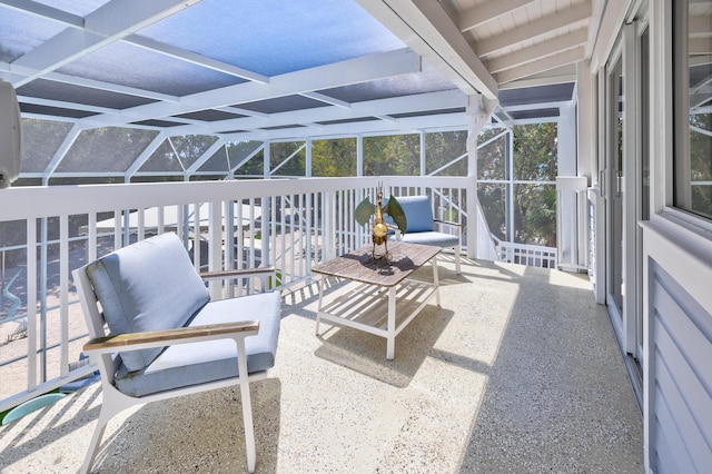 sunroom featuring beam ceiling