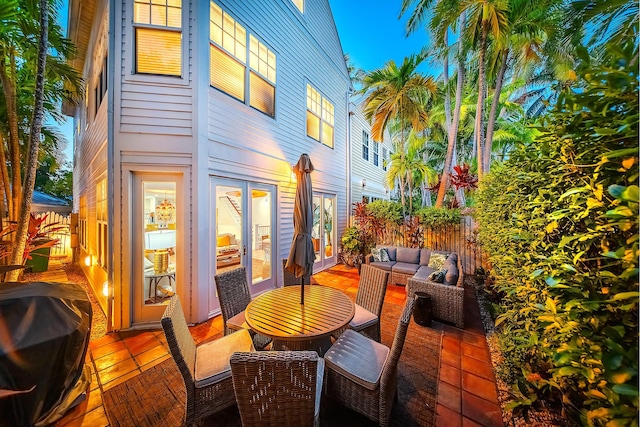 view of patio with an outdoor living space, area for grilling, and french doors