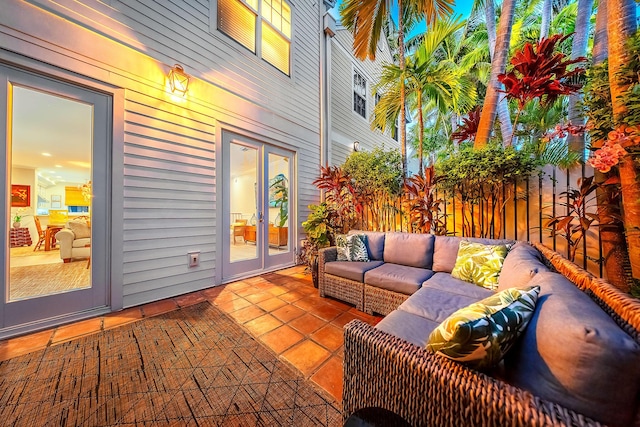 patio terrace at dusk featuring an outdoor living space