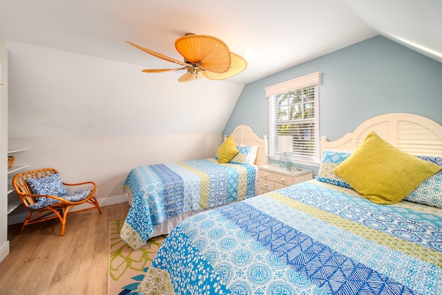 bedroom featuring ceiling fan, lofted ceiling, and light hardwood / wood-style floors