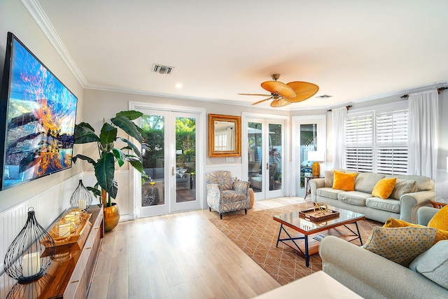 living room with french doors, ceiling fan, ornamental molding, and light hardwood / wood-style flooring