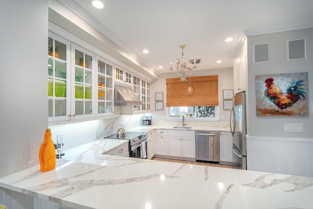 kitchen featuring appliances with stainless steel finishes, sink, white cabinets, and light stone counters