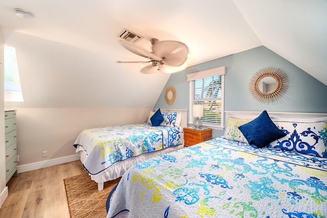 bedroom featuring ceiling fan, lofted ceiling, and light hardwood / wood-style floors