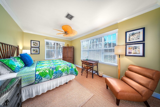 carpeted bedroom with ceiling fan and ornamental molding