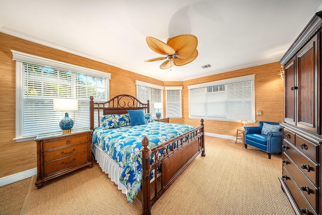 carpeted bedroom featuring ornamental molding and ceiling fan