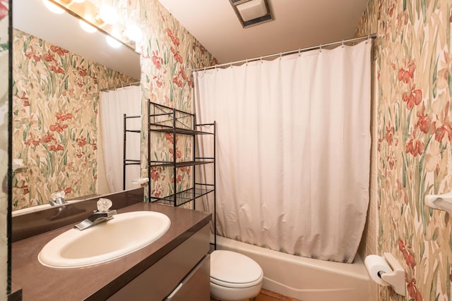 full bathroom featuring vanity, toilet, and shower / tub combo with curtain