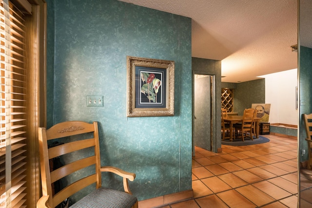 corridor with tile patterned floors and a textured ceiling