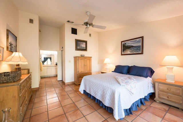 tiled bedroom featuring ceiling fan and ensuite bathroom