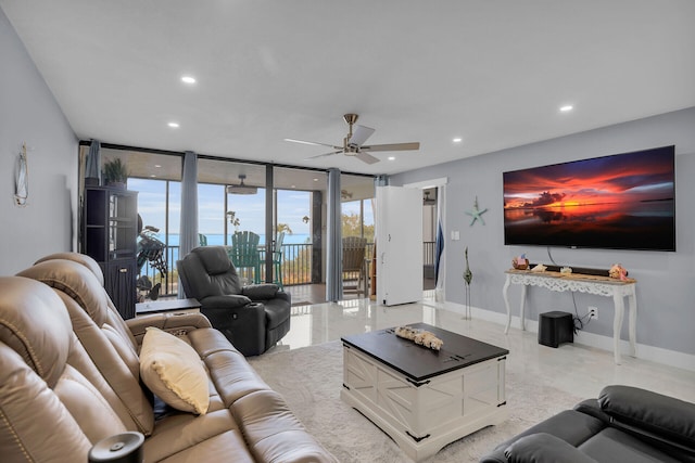 living area featuring baseboards, a wall of windows, and recessed lighting