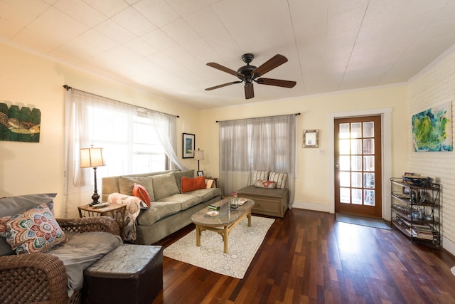 living area with ornamental molding, a ceiling fan, and wood finished floors