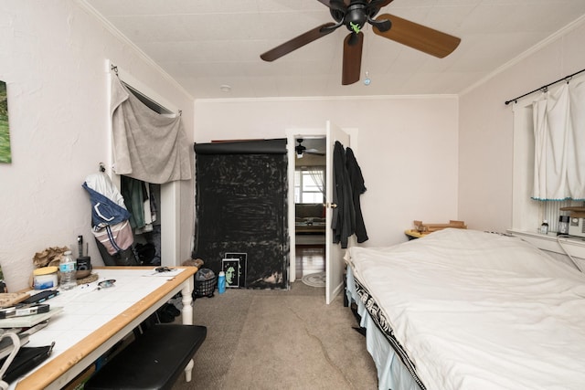 carpeted bedroom with ornamental molding and a ceiling fan