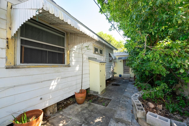 view of property exterior with a patio area