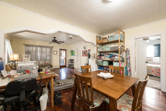 dining room with ornamental molding, arched walkways, ceiling fan, and hardwood / wood-style floors