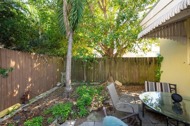 view of patio with a fenced backyard and outdoor dining area