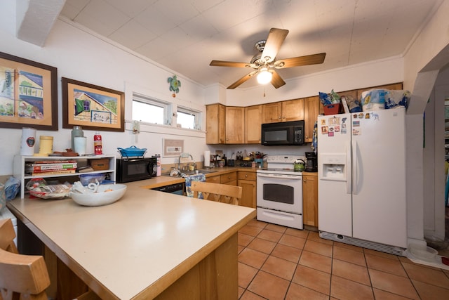 kitchen featuring crown molding, light countertops, a sink, white appliances, and a peninsula