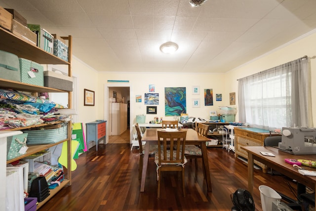 dining space with crown molding and wood finished floors