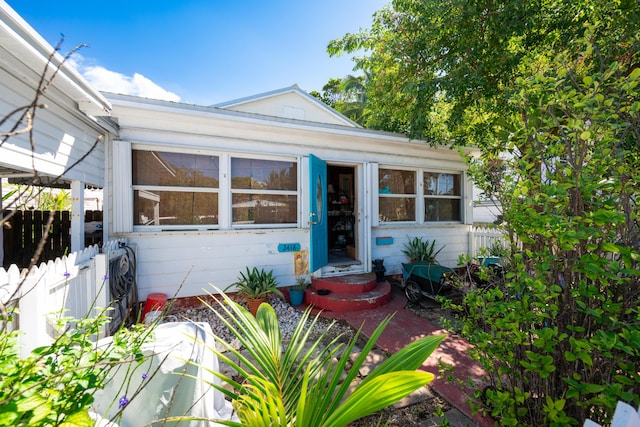 view of front of home featuring entry steps and fence