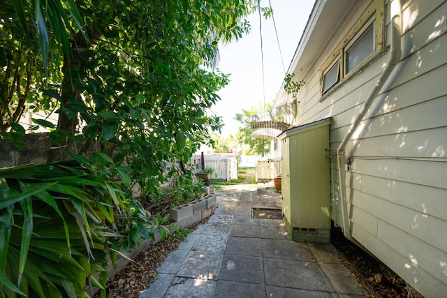 view of side of property with a patio and fence