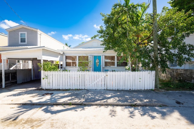 view of front of house with a fenced front yard and driveway