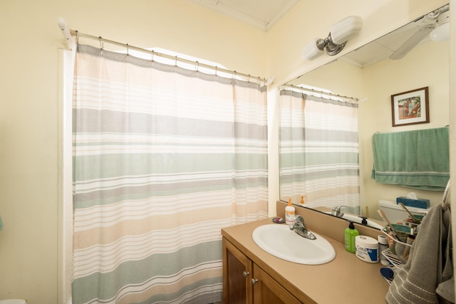 bathroom with a shower with curtain, vanity, and crown molding