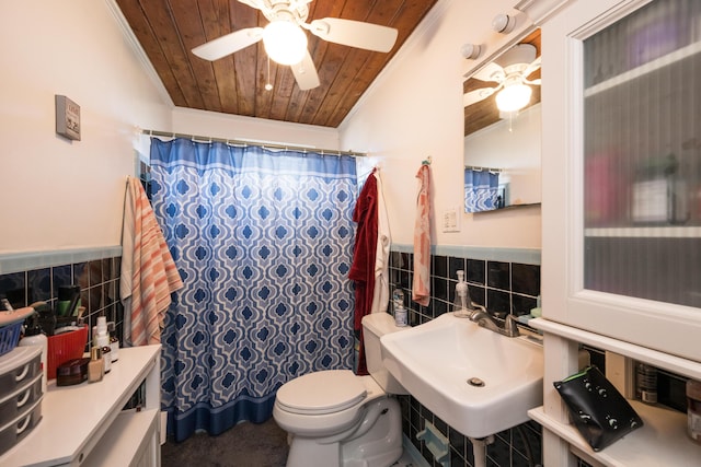 bathroom with a wainscoted wall, wood ceiling, ceiling fan, ornamental molding, and tile walls