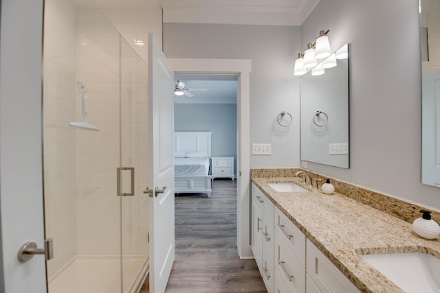 27215 Mariposa Rd, Ramrod, FL 33042 - bathroom featuring crown molding, double vanity, a stall shower, wood finished floors, and ceiling fan