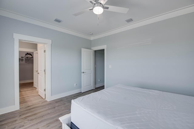 27215 Mariposa Rd, Ramrod, FL 33042 - bedroom featuring light wood-type flooring, baseboards, crown molding, a ceiling fan, and a spacious closet