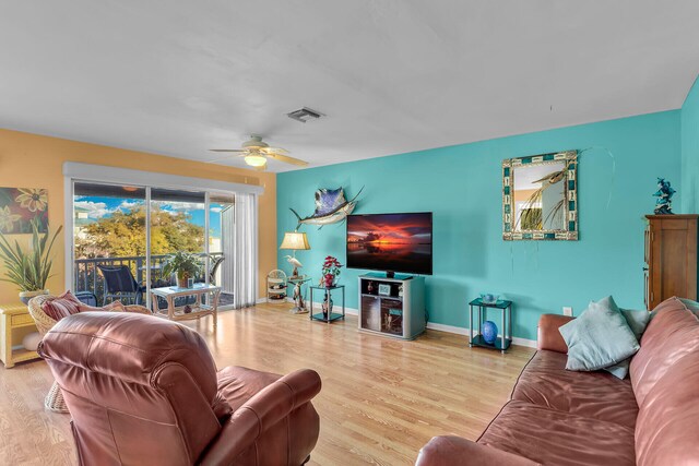 living room with hardwood / wood-style flooring and ceiling fan