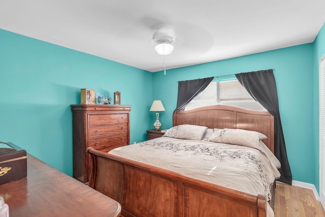 bedroom with hardwood / wood-style flooring and ceiling fan