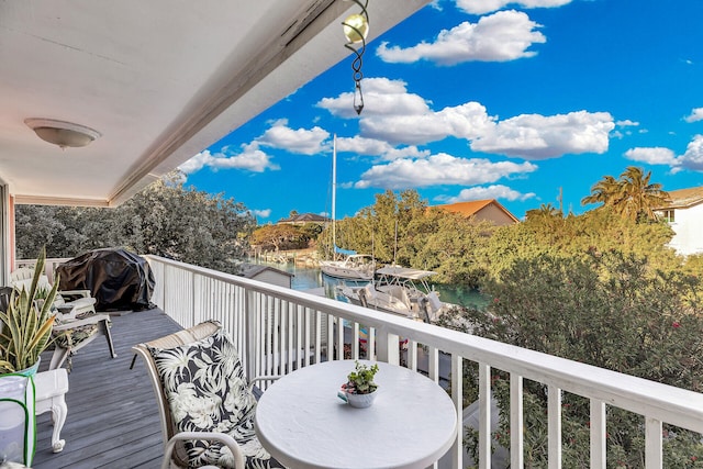 balcony featuring a grill and a water view