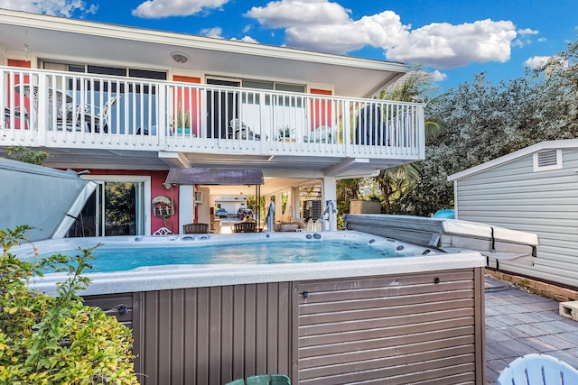 view of swimming pool featuring a hot tub