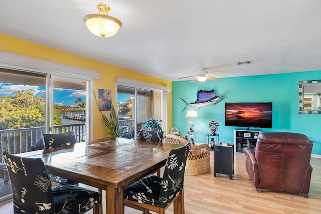 dining room with ceiling fan and light hardwood / wood-style floors