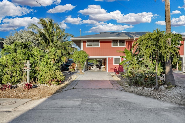 raised beach house featuring a carport