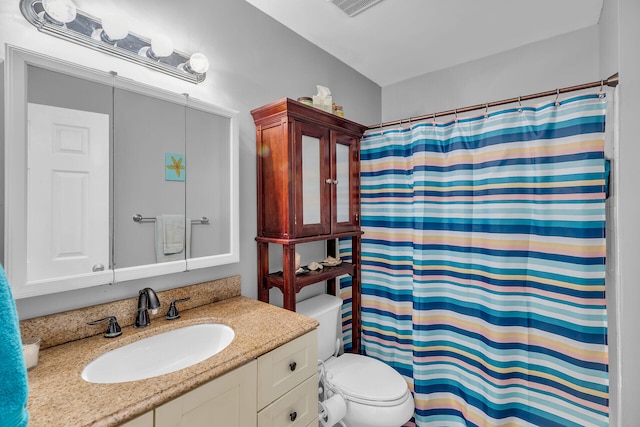 bathroom with a shower with curtain, vanity, and toilet