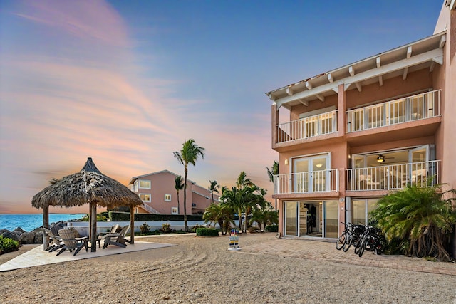 view of community with a water view and a patio area