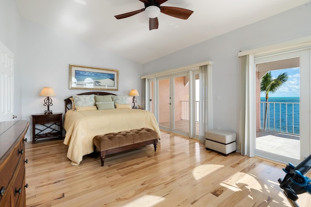 bedroom with a water view, access to outside, lofted ceiling, ceiling fan, and light hardwood / wood-style floors