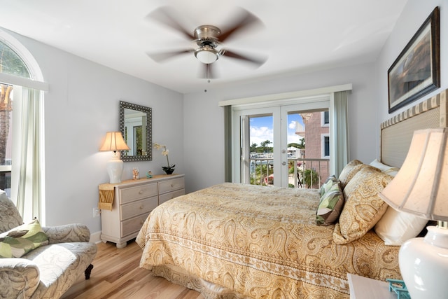 bedroom with light wood-type flooring, french doors, ceiling fan, and access to outside