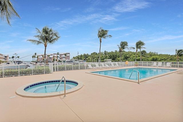 view of swimming pool featuring a patio area and a community hot tub