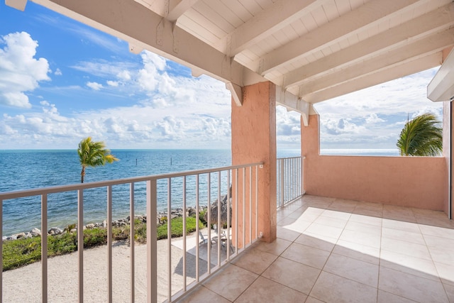 balcony with a water view and a beach view