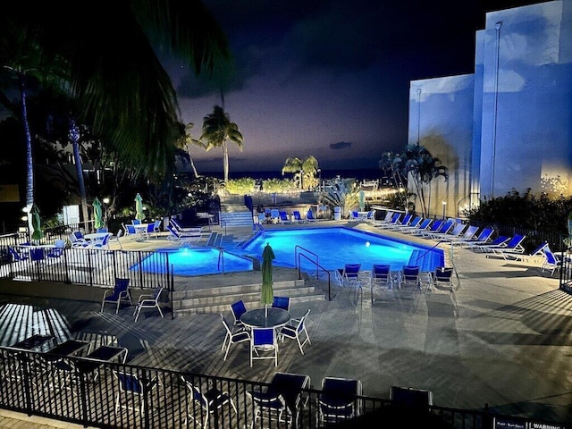 104350 Overseas Hwy Unit A204, Key Largo, FL 33037 - pool at twilight featuring a community pool and a patio