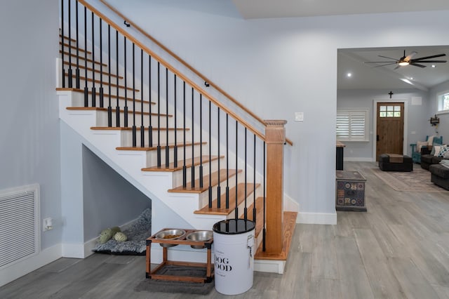 stairs featuring ceiling fan, wood finished floors, visible vents, and baseboards