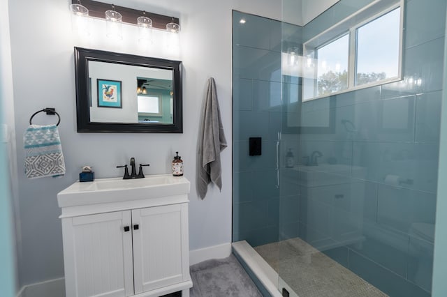 full bathroom featuring walk in shower, vanity, and baseboards