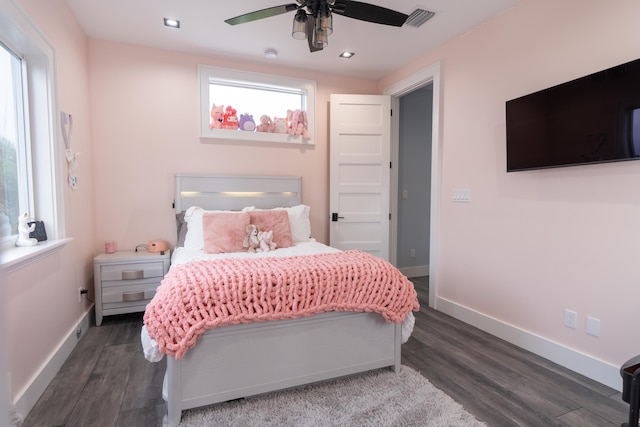 bedroom with dark wood-type flooring, visible vents, and baseboards