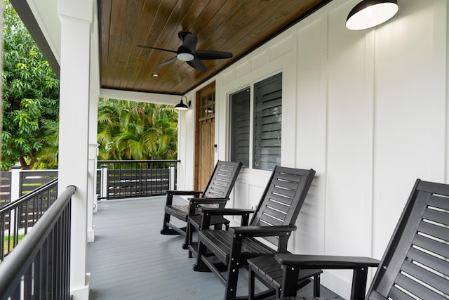 wooden terrace with a ceiling fan