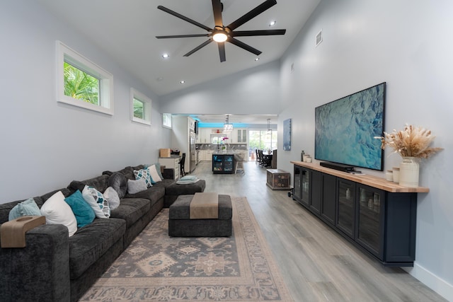 living room with recessed lighting, visible vents, light wood-style flooring, ceiling fan, and high vaulted ceiling