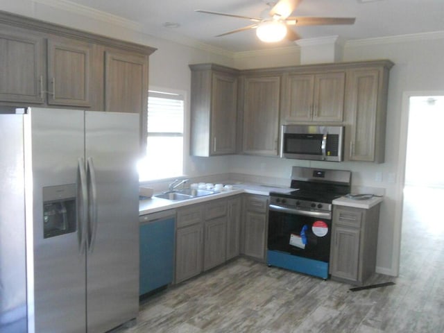 5413 3rd Ave, Stock Island, FL 33040 - kitchen featuring stainless steel appliances, ceiling fan, a sink, light countertops, and light wood-style flooring