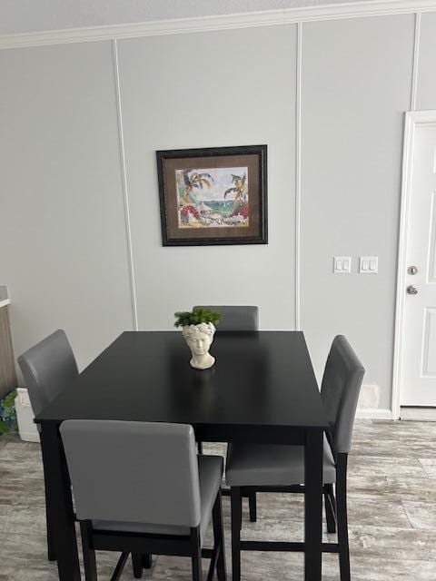 5413 3rd Ave, Stock Island, FL 33040 - dining space featuring light wood-type flooring and ornamental molding