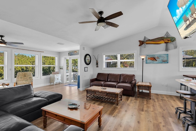 living room featuring lofted ceiling, plenty of natural light, ceiling fan, and light wood-type flooring