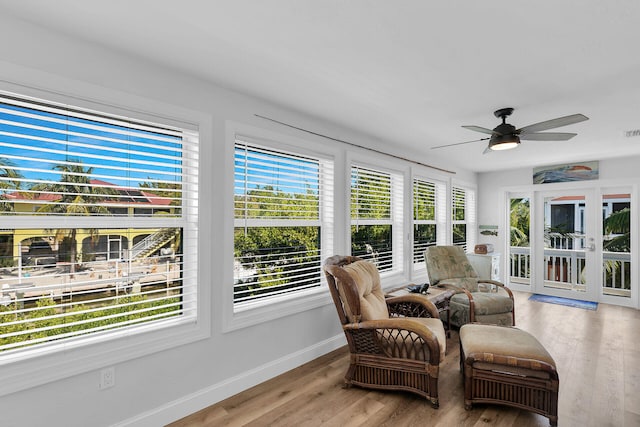 sunroom / solarium with a healthy amount of sunlight and ceiling fan