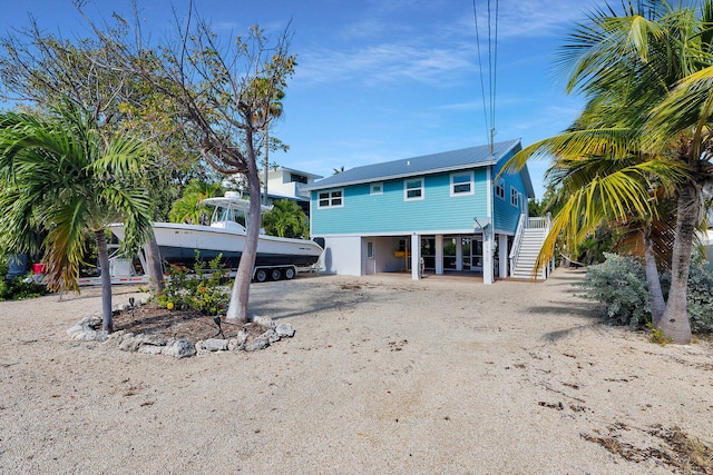 back of property with a carport